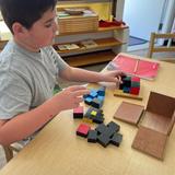 Children's Montessori School Photo #3 - Learning begins with the sensible experience like the trinomial equation in the form of a three dimensional puzzle.