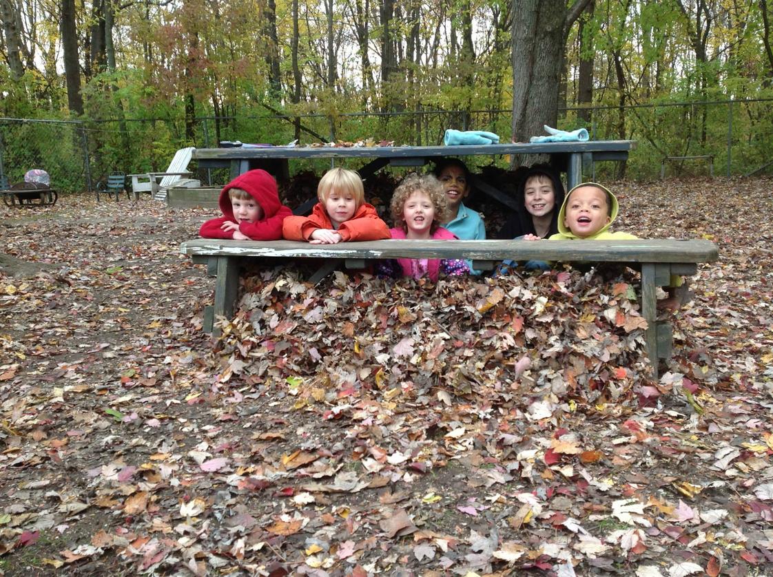 The Childrens House, Inc. Photo #1 - Leaf fort!! Hiding out with Isa, Liam, Riley, Fisher, Eva, and Teo!