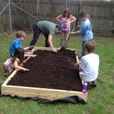 The Childrens House Photo #3 - Students help prepare the new garden bed for planting.