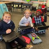 St. Ursula School Photo #4 - 2nd and 3rd grade students work on their Chromebooks together.