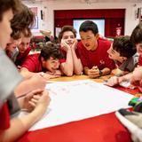 Catholic Memorial Photo #9 - Middle schoolers collaborate on the floor of the Ronald Perry gym.