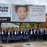 Immaculate Heart Of Mary School Photo #8 - IHM has a strong pro-life history. High School students stand near a billboard they sponsored.