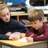 The Imago School Photo - One of our 7th grade students helping her 1st grade "Buddy" fill out his profile page to include in his Operation Christmas Child shoe box.