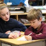 The Imago School Association Photo #1 - One of our 7th grade students helping her 1st grade "Buddy" fill out his profile page to include in his Operation Christmas Child shoe box.