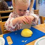 Christian Montessori School Of Ann Arbor Photo #8 - Cutting apple work. Children's House.