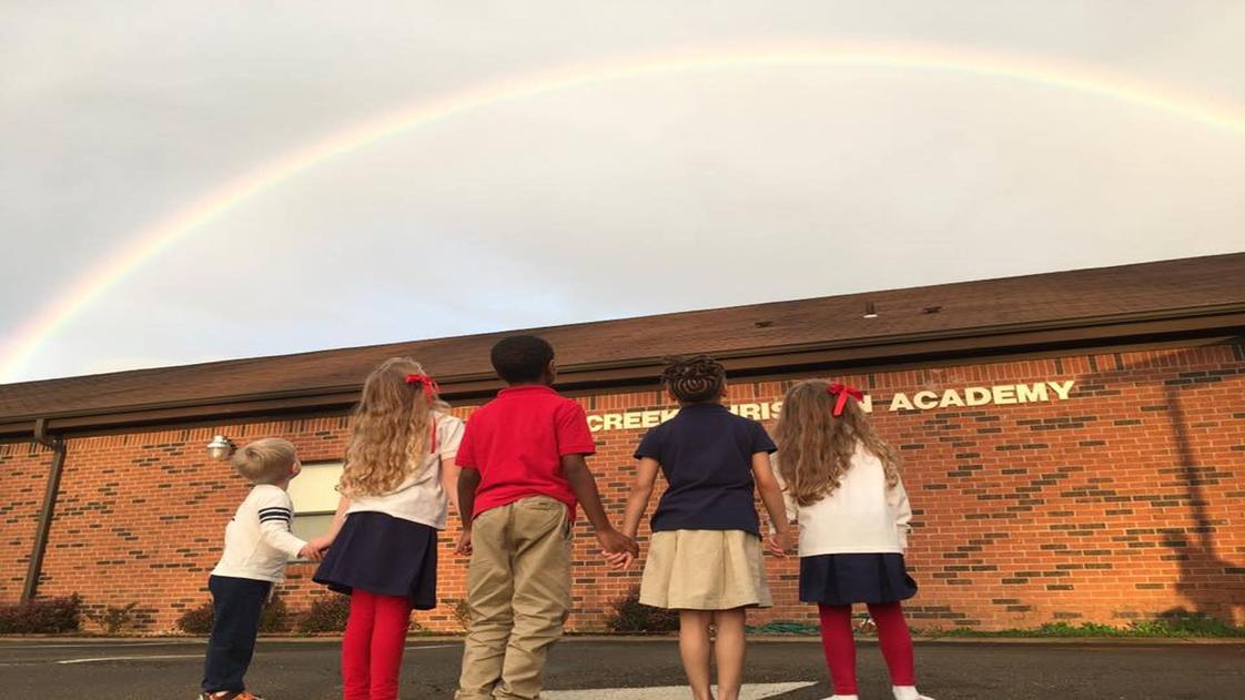 Cross Creek Christian Academy Photo - Students admiring a beautiful rainbow God has provided after a rainy afternoon.