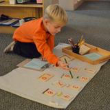 Foothills Montessori School Photo #7 - Using the short bead stair for counting and identifying corresponding numerals.