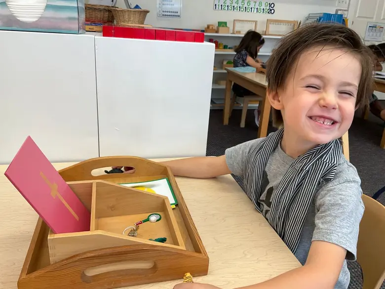 The Red Oaks School Photo #2 - Our Early Childhood program is pure Montessori. Here's a child using the quintessential sandpaper letter activity. Curious? Visit Red Oaks.