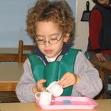 New World Montessori School Photo #10 - Practical life skills such as pouring, develop eye hand coordination and fine motor skills.