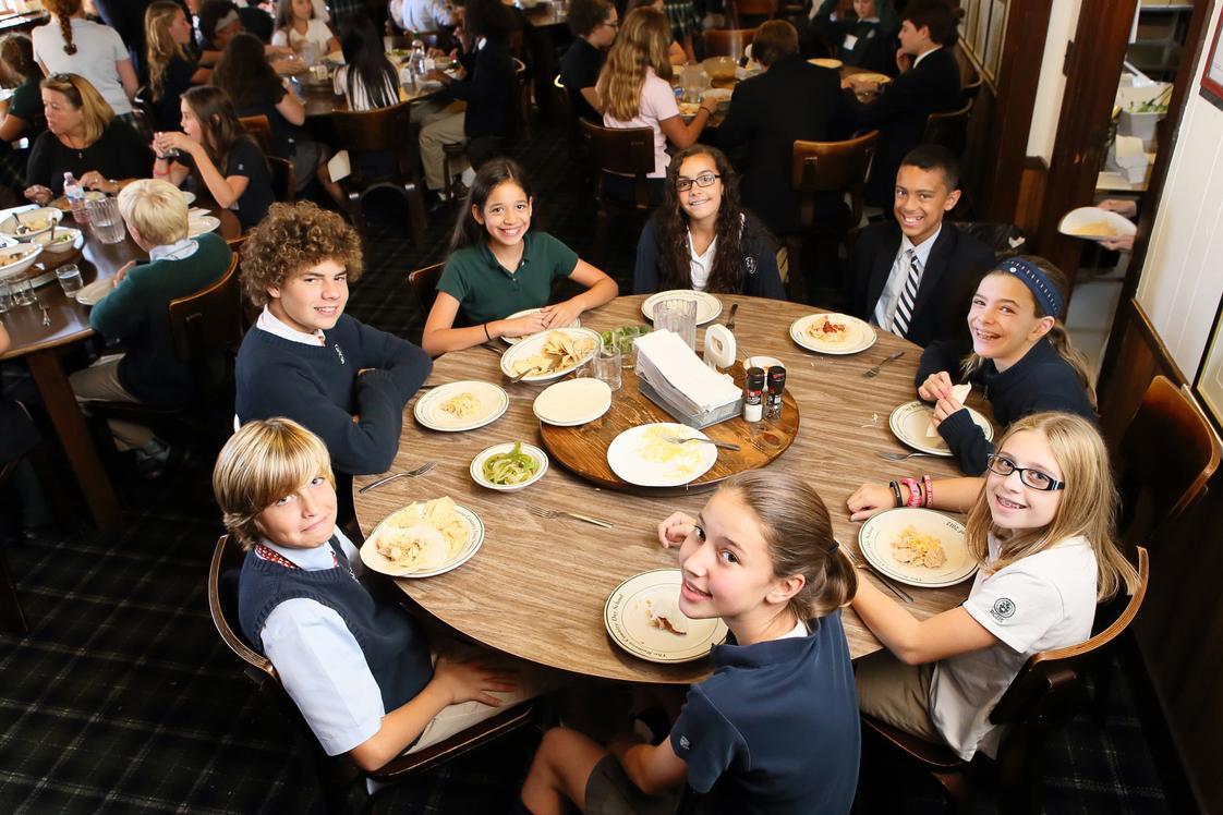 Rumson Country Day School Photo - Lunch is served family style in our dining room. Each table is thoughtfully comprised of mixed age students and one faculty or staff member.