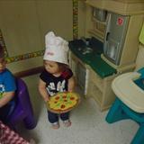 Springdale Road KinderCare Photo #9 - Emma pretending to be a pizza chef in dramatic play.