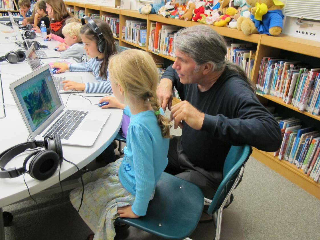 Rio Grande School Photo #1 - 1st grader with our Technology Director in the Media Lab.