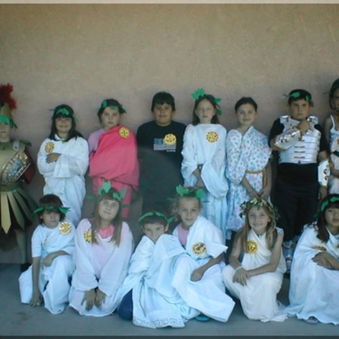 Grace Lutheran Preschool Photo - Third Grade History studies Ancient Rome. Here the class is pictured on the final day of the unit, experiencing Roman dress, food, and activities.