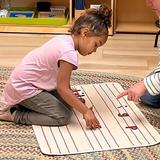 Santa Rosa Montessori Photo - Sounding it out and building words! This 3.5-year-old is making words with material designed to support early writing skills. Montessori makes early literacy fun and hands-on.