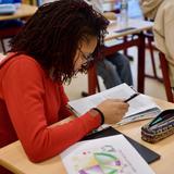 The Waldorf School Of Garden City Photo #3 - High School student focused on written work in her Main Lesson book.