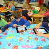 Fayetteville Academy Photo #3 - The Fayetteville Academy pre-kindergarten class use iPads to practice writing the alphabet.