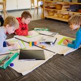 Greensboro Montessori School Photo #4 - Kindergartners are ready for multistep research projects and group work. These kindergartners are working on a project about Venezuela.