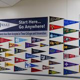 Wake Christian Academy Photo #4 - This wall in our auditorium pays tribute to our graduates and is a wonderful visual representation of their hard work! We're proud of our network of alumni, working and serving the Lord all over the world.