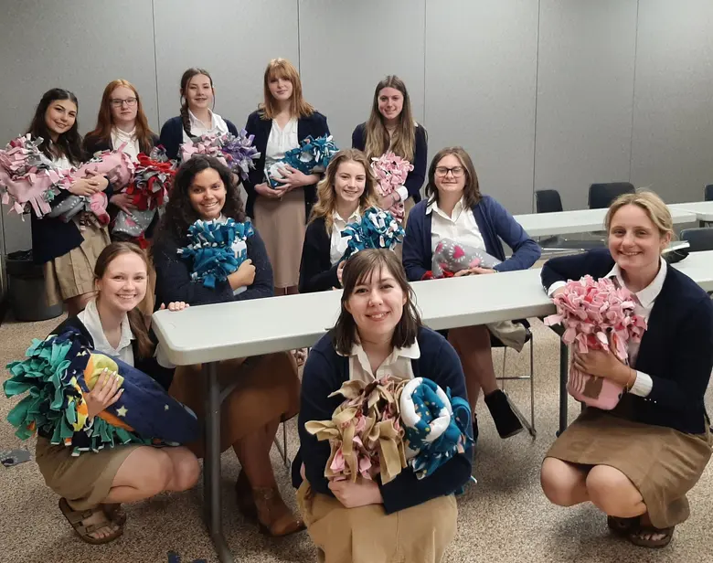 East Richland Christian Schools Photo #2 - High School small group presents blankets that they made for a local shelter.