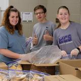 Wesleyan Christian School Photo #8 - Packing food boxes for community service