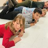 Swallowtail Waldorf School & Farm Photo #6 - In the 3rd grade measurements block, students learn about various measurement systems throughout history and around the world. Here they measure our hallways in cubits. Whenever possible, movement and physical experience are incorporated into the learning.