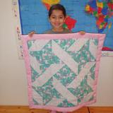 Garden Montessori School Photo #6 - Each child makes a quilt in their Kindergarten year. They use their skills in geometry, color matching and patterning. The entire process is a great lesson in perseverance and start to finish process.