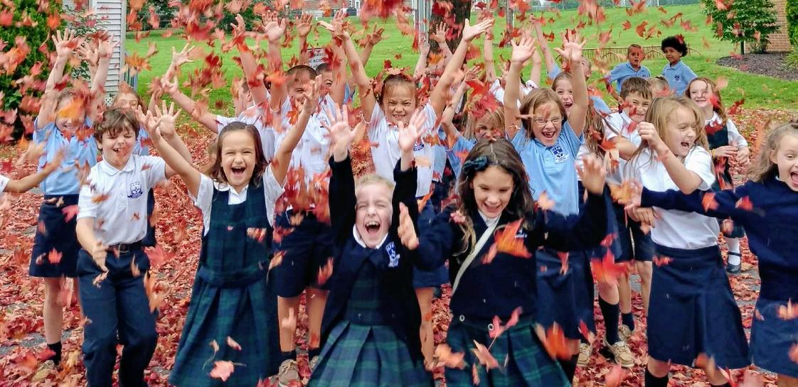 Our Lady Of Perpetual Help School Photo - Students rejoice in the autumn colors after a music class. Call us today to find out how your child can be a part of our family too!