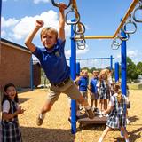 Overbrook Catholic School Photo #7 - Students playing on the monkey bars at recess.