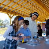 Overbrook Catholic School Photo #8 - Students conducting a science experiment in the outdoor learning pavilion, located on Overbrook Catholic School's 83 acres in the heart of Nashville.