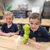 Sumner Academy Photo #3 - Kindergartners testing critical thinking and problem-solving skills during an IDEA Hub challenge to stack as many apples as possible.