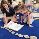 Jack Segal Academy (formerly BYDS) Photo #2 - Segal Elementary students read to younger Segal buddy students using books and hand-painted story stones