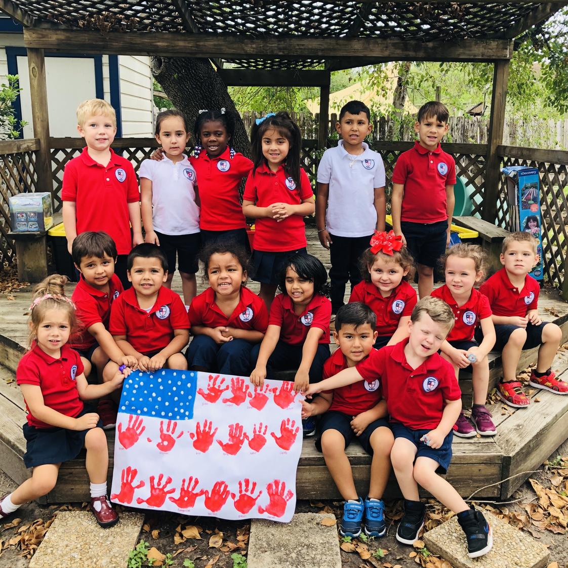 Epiphany Montessori School Photo #1 - Epiphany students showing off their hand-made U.S. Flag in observance of Veteran's Day.