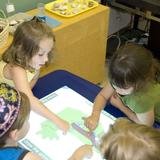 Ann & Nate Levine Academy Photo #2 - Early Childhood Center Children working on SMART Tables.