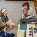 Cascadia School Photo #2 - First year students receiving a lesson on division with the Montessori materials.