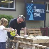 The Clearwater School Photo #5 - Staff member, Mat, collaborating with a student to make flower beds out of reclaimed pallets.