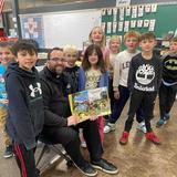 Sacred Heart Catholic School Photo #12 - Father Edward reads to our students to deepen a love of learning and their faith.