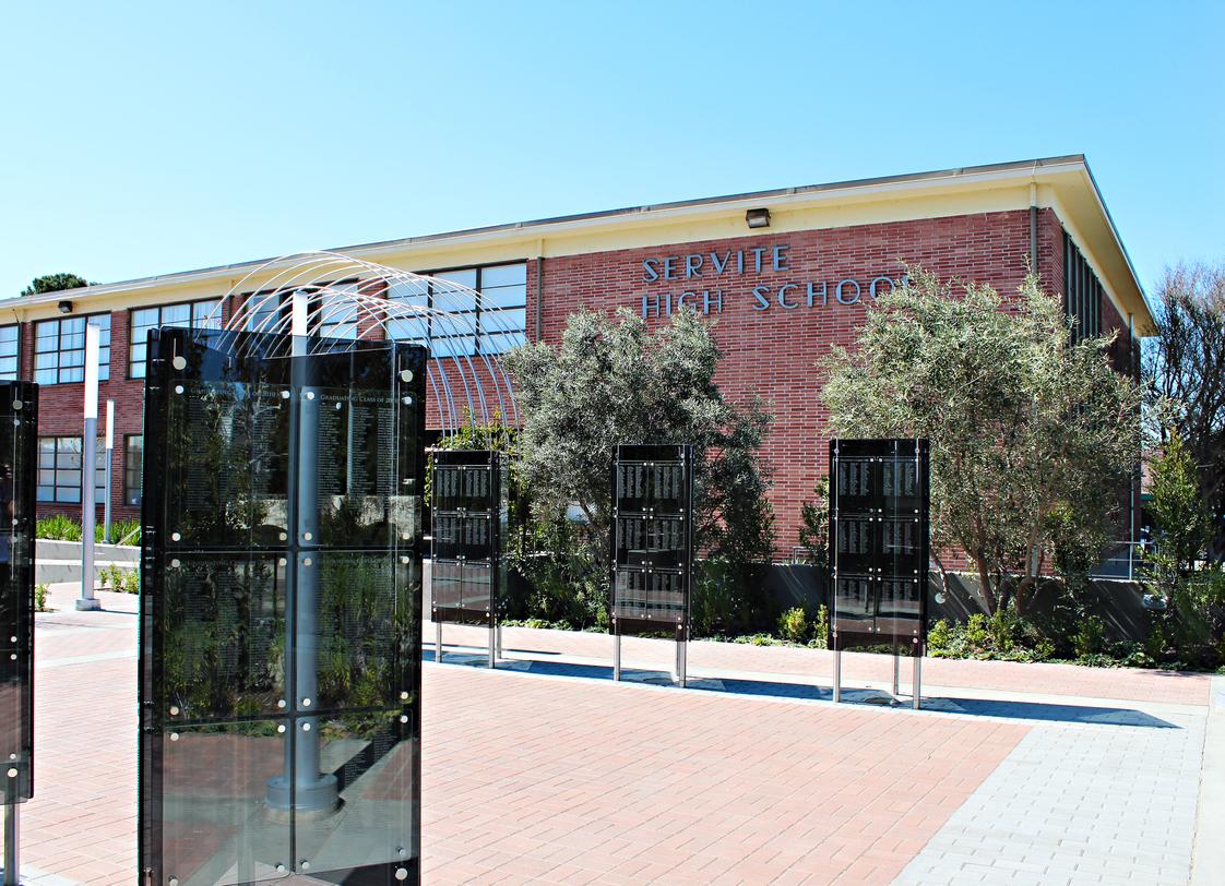 Servite High School Photo - The Alumni Garden is a patio surrounded by triangular glass installations that list every graduate of Servite by class year. It is a gathering place for alumni reunions, socials and sharing Servite memories.