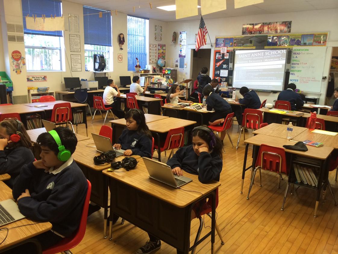 St. Annes School Photo - Class engaged in blended learning. Half of the class in direct instruction with the teacher, half engaged in personal digital learning on individual learning profiles on chromebooks.