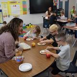 Cross Of Glory Lutheran School Photo #2 - Kindergarteners enjoying apple day with activities like taste tests, measuring weight, and making apple smiles with marshmallow teeth.