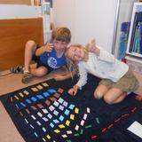 Montessori De Terra Linda Photo #4 - Two Lower Elementary (ages 6-9) students give a "thumbs up" to Montessori math.