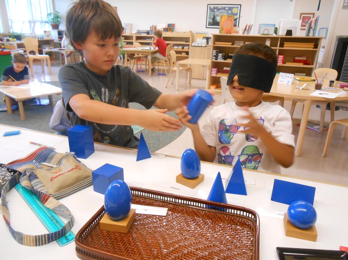 Montessori De Terra Linda Photo - Two Lower Elementary (ages 6-9) students work together to explore the geometric solids.
