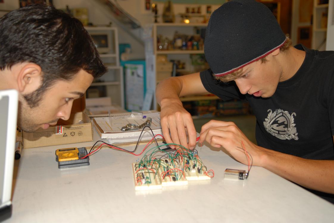 Merit Academy Photo #1 - Engineering a brake-light system. All students engage in ProjectMERIT where they start an independent project that teaches them leadership and critical thinking skills in the real world. These projects separate Merit Academy students from their peers in the competitive college admissions process.