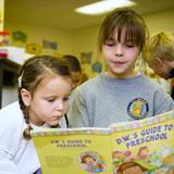 St. Mark Catholic School Photo #3 - Older "buddies" read to younger students.