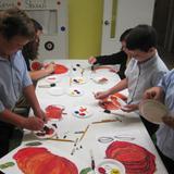 Wanchese Christian Academy Photo #4 - Students painting pumpkins in their Thursday art class . Wanchese Christian Academy's halls always look festive with the seasonal artwork on display.