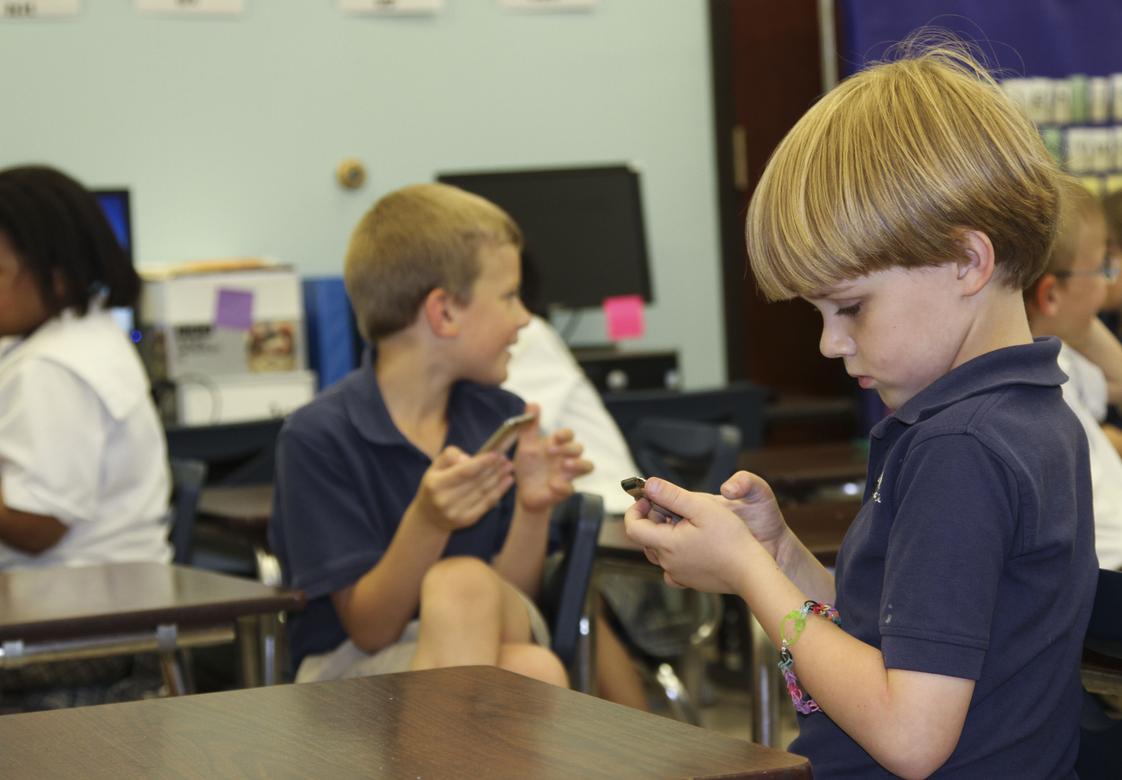 Christ Covenant School Photo - Lower School students use iPod Touches to play interactive learning games in specific subjects.