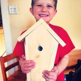 Plumfield Academy Photo #3 - The proud owner of a completed woodworking project! The youngest among us are taught proper safety techniques and allowed to participate and create beautiful things with the older students.