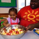 Alexandria KinderCare Photo #4 - The Discovery Preschool class (2s) get to learn through fun cooking projects. Counting the fruit helps teach math for kids.