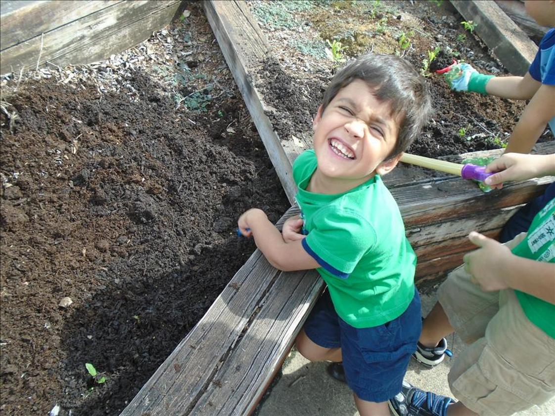 Clear Lake KinderCare Photo - Fun in the sun while planting our vegetable garden.
