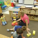 New Lenox KinderCare Photo #10 - Miss Joanne loves to get on the floor with us and build. Today we are building a castle!