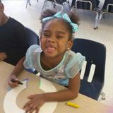 Matteson KinderCare Photo #4 - Preschool student being silly while working on her letter collage.